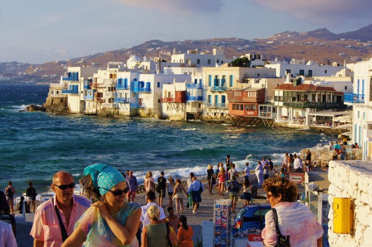 tłum turystów w tle stare kamienice z kolorowymi elementami nad morzem