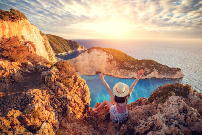 Woman tourist in Zakynthos, Greece admiring the Navagio beach