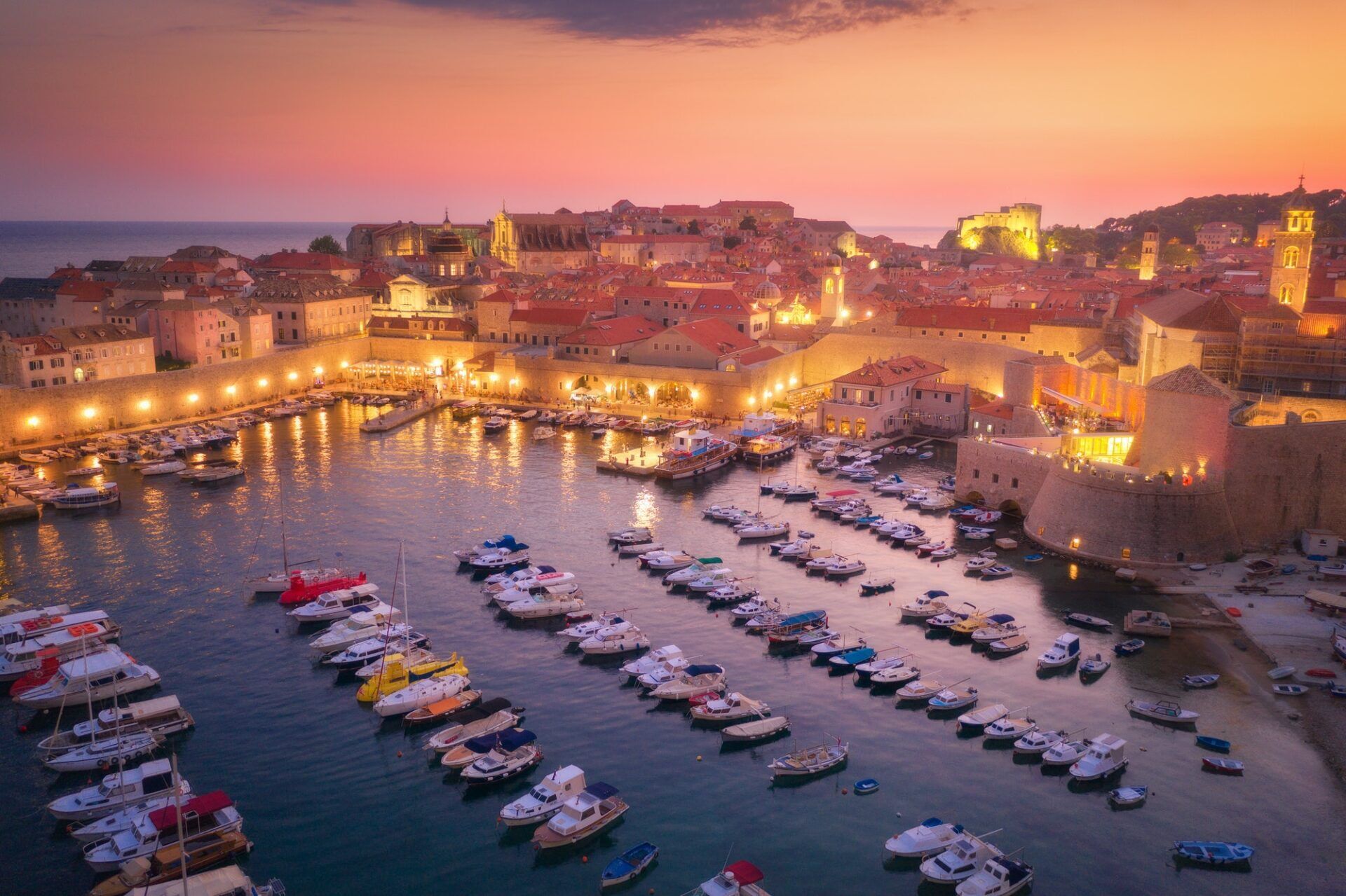 Aerial view of houses with red roofs at night in Dubrovnik