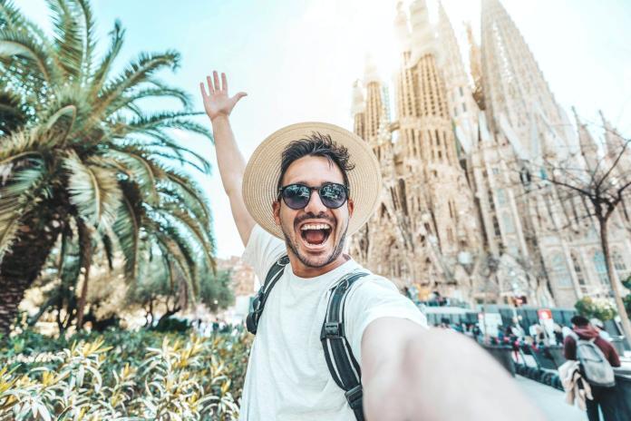 Happy tourist visiting La Sagrada Familia, Barcelona Spain