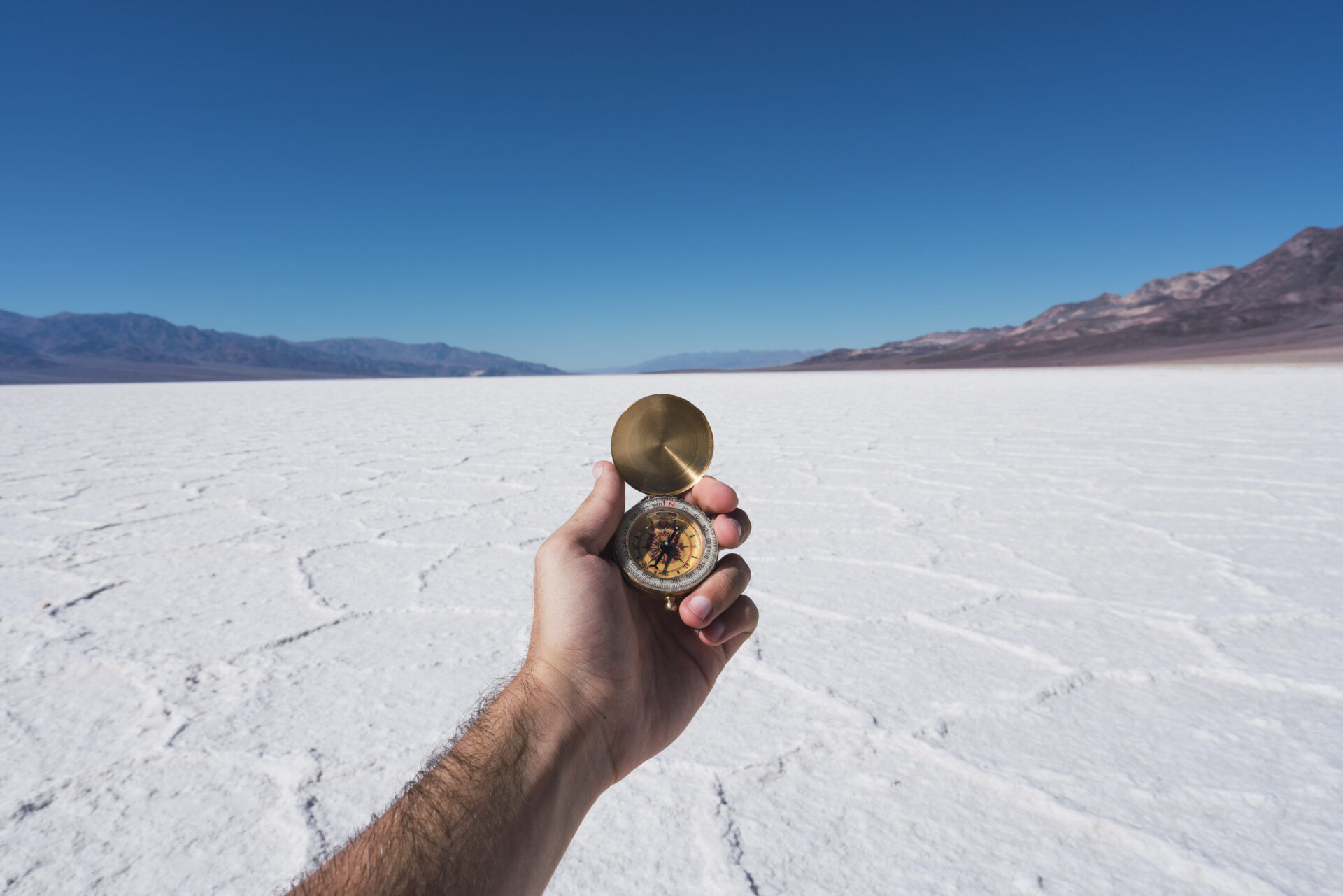 USA, California, Death Valley, man's hand holding compass