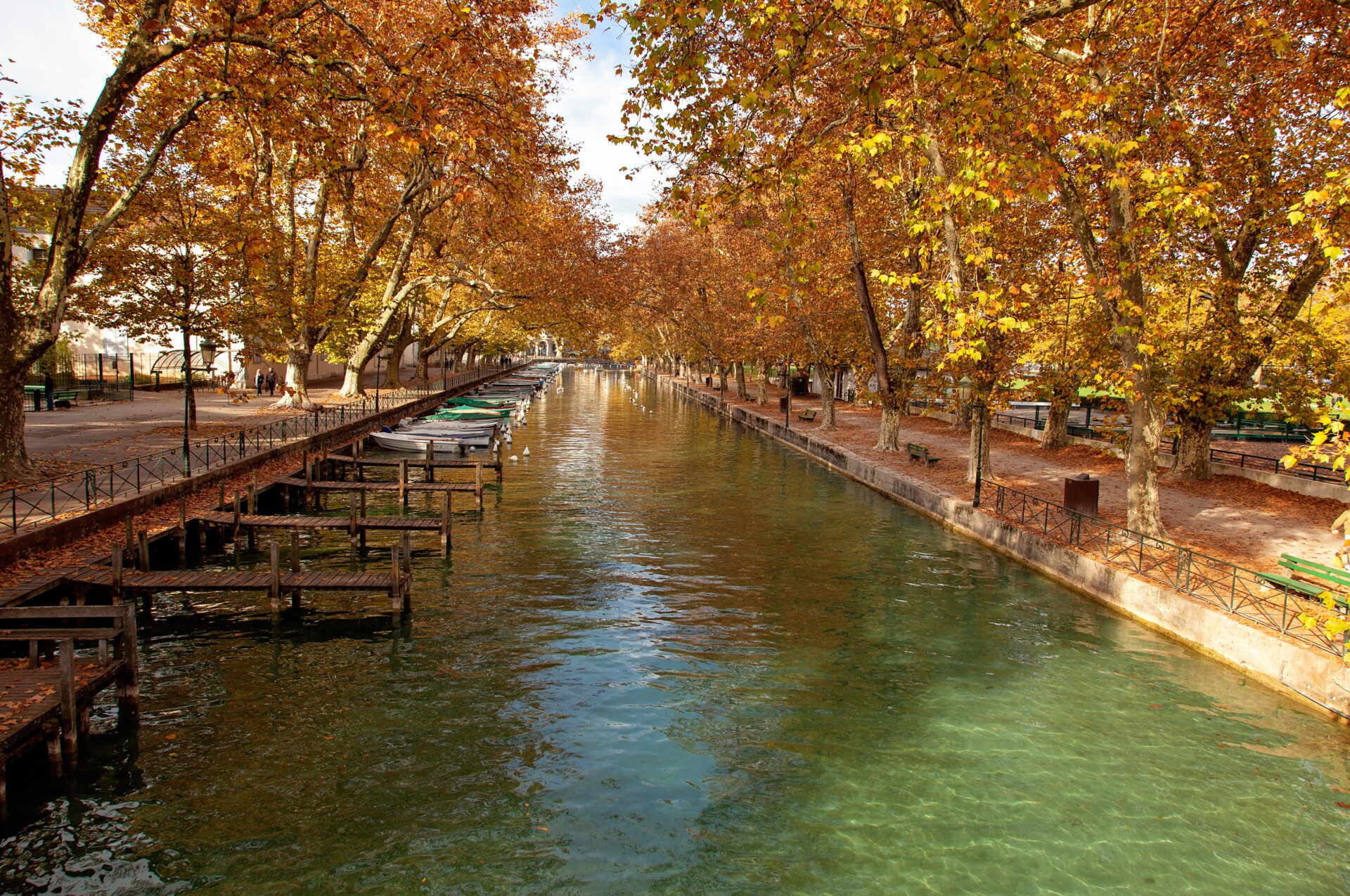 View to the Annecy lake and channel with boats in autumn