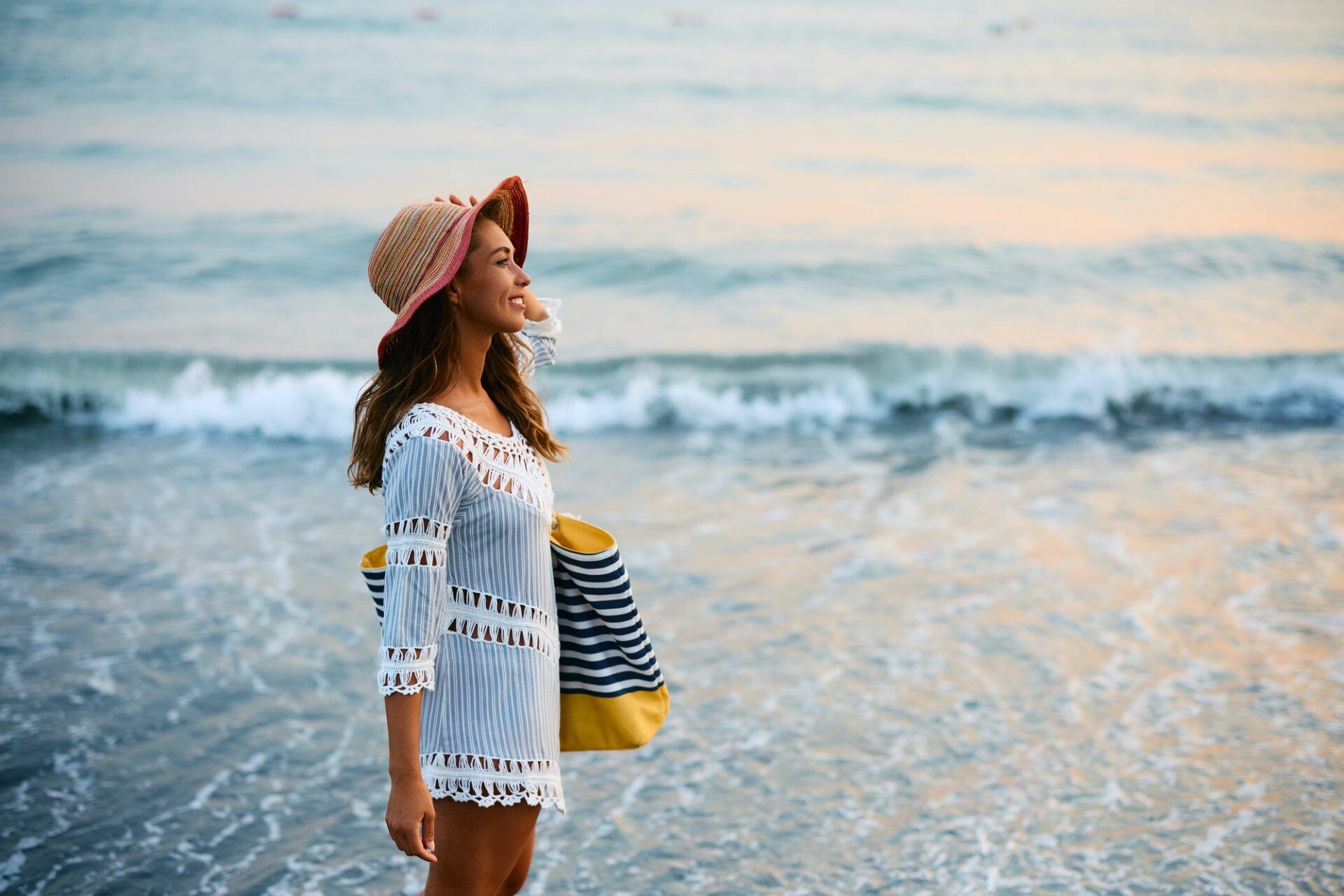 Smiling woman enjoying on the beach during her summer vacation.