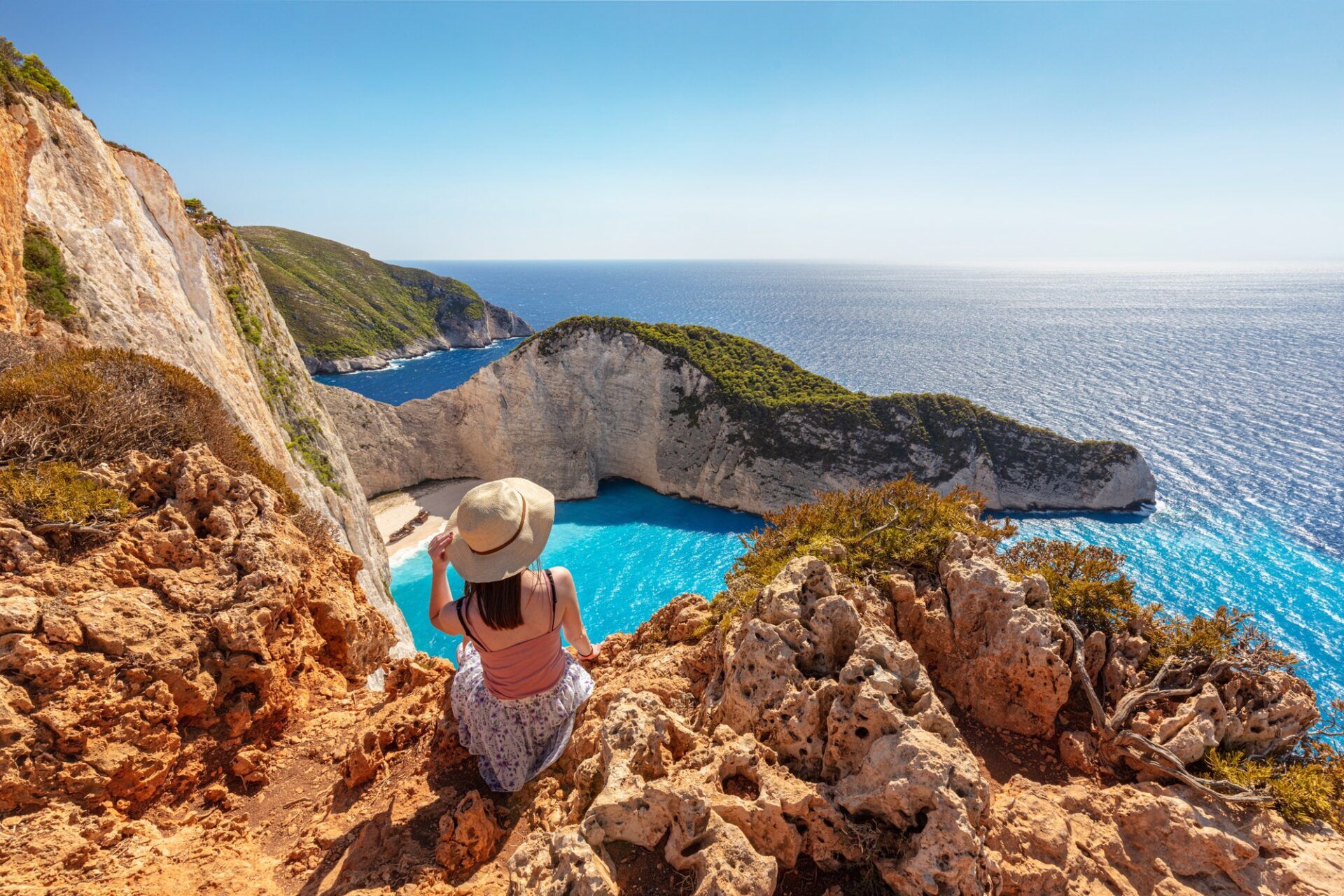 Woman tourist in Zakynthos, Greece admiring the Navagio beach