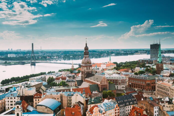 Riga, Latvia. Riga Cityscape Slyline In Sunny Summer Day. Famous Landmarks - Riga Dome Cathedral And