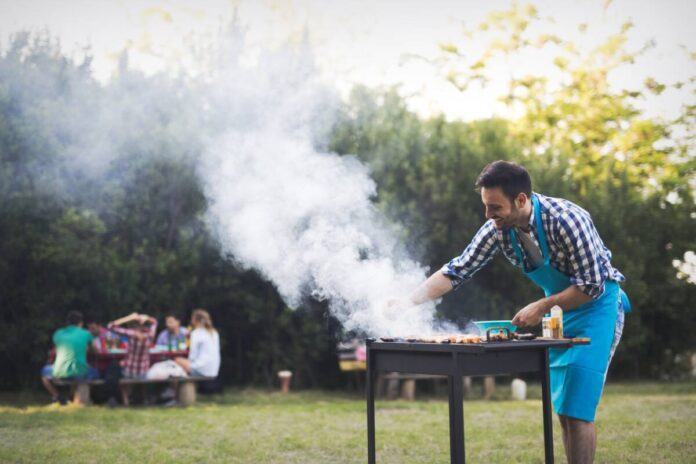 Handsome man preparing barbecue