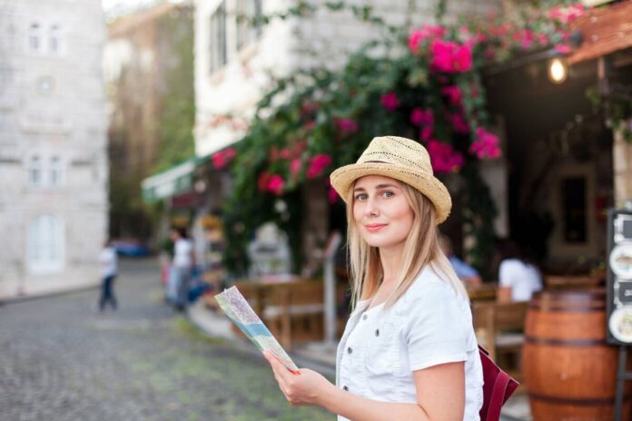 Girl traveler is smiling with city map