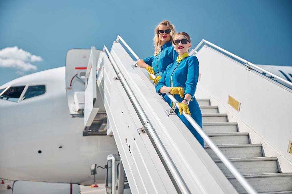 beautiful stewardesses standing on airplane stairs 2021 09 03 21 02 49 utc