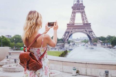 tourist-taking-photo-of-Eiffel-tower-in-Paris-with-compact-camera-or-smartphone-travel-in-Europe-shutterstock_424114555-1