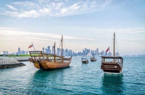 Doha-Dhows-moored-off-Museum-Park-in-central-Doha-Qatar-Arabia-with-some-of-the-buildings-from-the-citys-commercial-port-in-the-background.-shutterstock_252379561-2