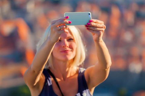 Female-traveller-make-a-selfie-photo-against-the-background-of-the-old-city-of-Dubrovnik-Travel-to-Croatia.-Summer-vacation-shutterstock_461601025