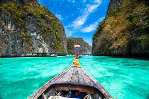 Traditional-wooden-boat-in-a-picture-perfect-tropical-bay-on-Koh-Phi-Phi-Island-Thailand-Asia.shutterstock_129916532-1