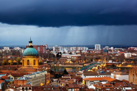 Rainy-evening-in-Toulouse-France-view-on-La-Grave-hospital-and-Saint-Pierre-bridge-Saint-Syprien-district-Tuluza-shutterstock_130545686