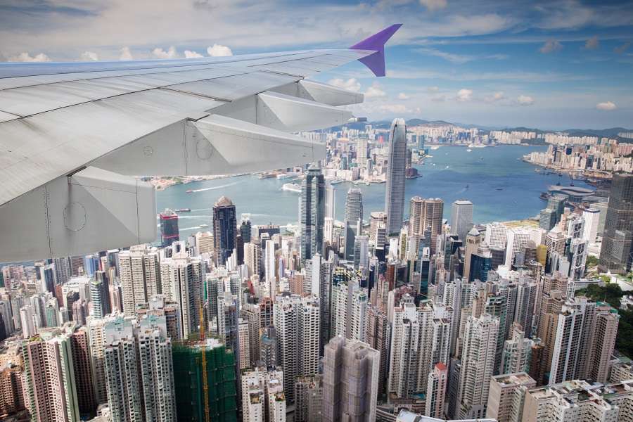 Top-view-of-Hong-kong-Kowlon-and-wing-of-airplane-from-window-of-airplane-just-take-off-from-Hongkong-international-airport-Hongkong-city-China-shutterstock_686676640