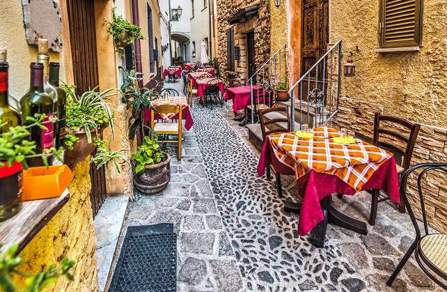 rustic-tables-in-Castelsardo-old-town-Sardinia-Sardynia-shutterstock_493854382